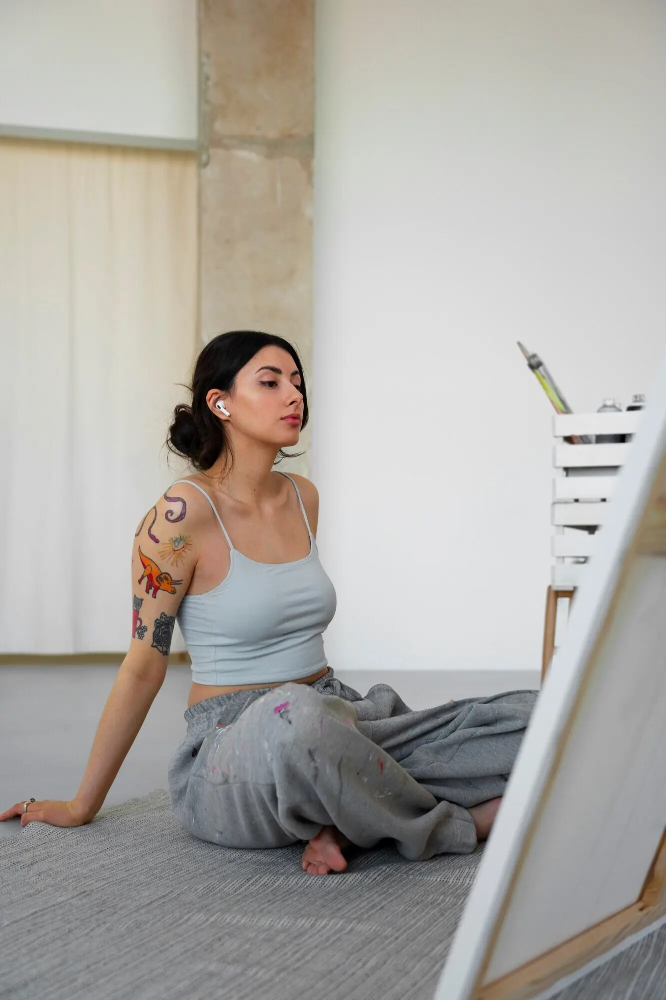 A woman without a bra working indoors.