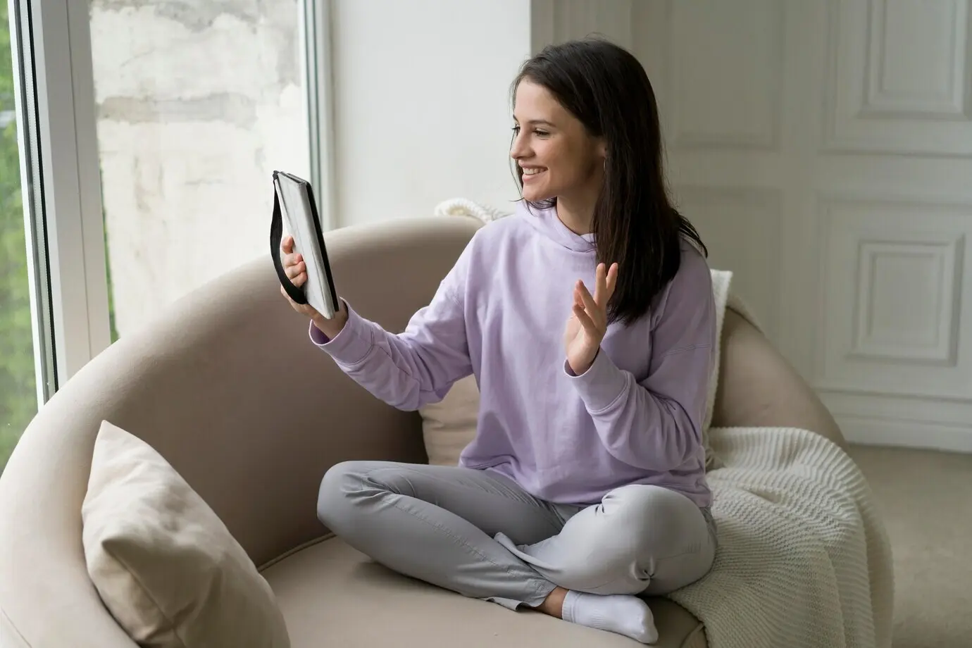 A beautiful woman is on a video call at home.